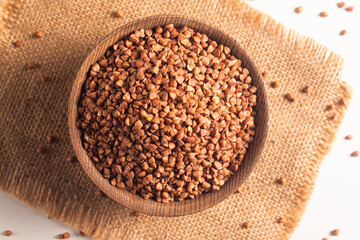 Buckwheat groats on wooden background. Healthy cereal concept.  