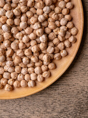Raw Chickpeas on a rustic wooden table. Dry chickpea background close up. Chickpea legumes seed background.