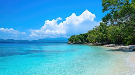 Fototapeta premium View across tranquil waters, from shallow aqua shades into the mysterious royal blue of the open sea