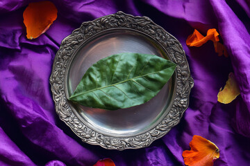 Close-up of a Paan Leaf Placed on a Decorative Silver Plate With Vibrant Petals