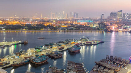 Dubai creek landscape day to night timelapse with boats and ship near waterfront