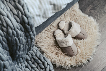 Female soft slippers on faux fur rug