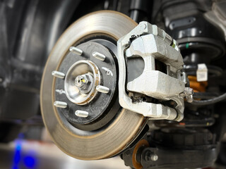 Car brake disc with grey caliper. Modern brake disc with holes and cooling. Brake disc and wheel...