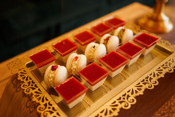 Cakes and pastries on a decorative stand. Sweet table.