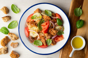 Panzanella is an Italian salad with bread, basil, bell pepper, cucumber, and tomato, popular in the Florence region.