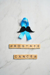 Prostate cancer awareness month and men health Blue ribbon with mustache
