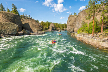 Two groups raft down the rapids along the Spokane River at the Bowl and Pitcher area inside...