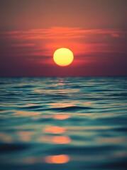 Obraz premium Vivid sunset over tranquil ocean