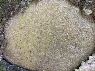Weathered Stone Surface with Natural Texture. Close-up view of an aged stone wall showing natural...