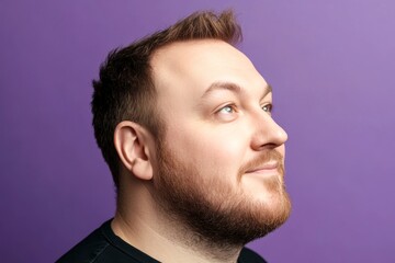 Fototapeta premium A masculine beauty with a relaxed and happy expression. Purple solid background. Trendy men's low fade haircut - midlife white man with hair. Conceptual art of style for aging men.