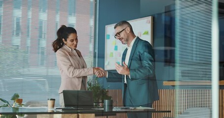 Handshake, deal and business people in office with investment negotiation, agreement or welcome. Greeting, merger and finance manager shaking hands with client for partnership, contract or thank you.