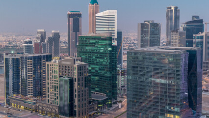 Obraz premium Panorama of Business bay Dubai night to day aerial timelapse.
