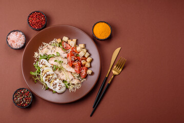 Bowl with caesar salad with chicken, parmesan cheese, tomatoes, croutons, lettuce leaves
