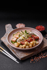 Bowl with caesar salad with chicken, parmesan cheese, tomatoes, croutons, lettuce leaves