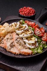 Bowl with caesar salad with chicken, parmesan cheese, tomatoes, croutons, lettuce leaves