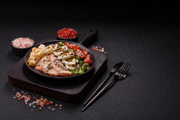 Bowl with caesar salad with chicken, parmesan cheese, tomatoes, croutons, lettuce leaves