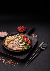 Bowl with caesar salad with chicken, parmesan cheese, tomatoes, croutons, lettuce leaves