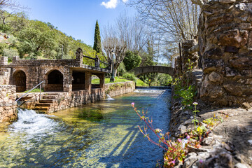 A fenced spring, a historic site that occasionally becomes a swimming pool. Old walls of the Praia...