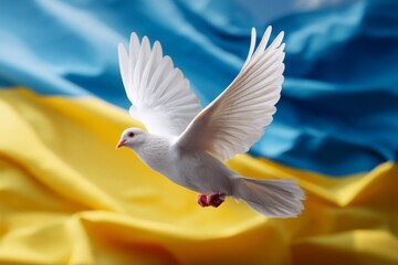 White dove in flight with wings spread wide in front of a waving Ukrainian flag. Represents peace, hope, and national symbolism.