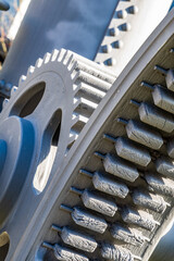 Detailed view of interlocking gears working together in a mechanical system during daylight