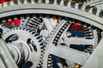 Detailed view of interlocking gears working together in a mechanical system during daylight