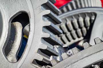 Detailed view of interlocking gears working together in a mechanical system during daylight