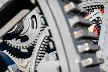 Detailed view of interlocking gears working together in a mechanical system during daylight