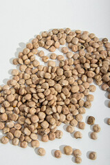 Lupine seeds on white background. A bunch of lupine seeds. Vertical. Soft focus