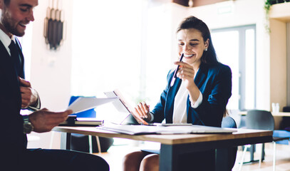 Businessman helping colleague with paperwork in office