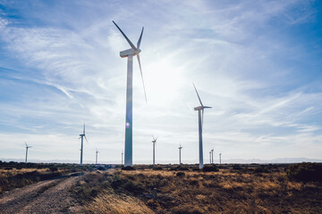 Wind turbines against partly cloudy sky