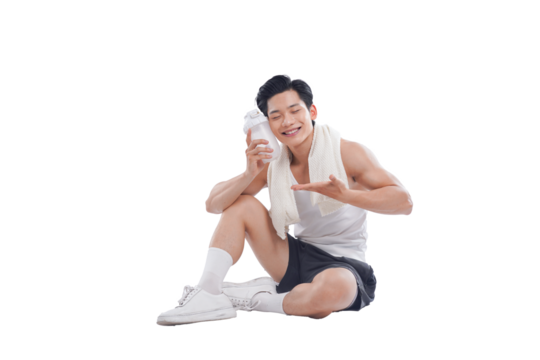 Portrait of muscular Asian man in sportswear sitting posing on white background