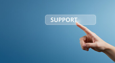 Fototapeta premium A hand pressing a support button on a blue background offering assistance and customer service online