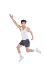 portrait of muscular asian guy in sportswear high jump posing on white background