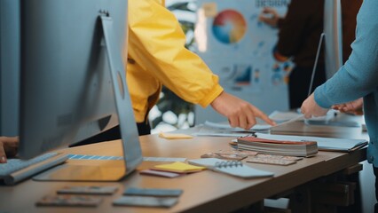 A vibrant workspace showcases professionals engaged in collaborative design activities. Colorful...