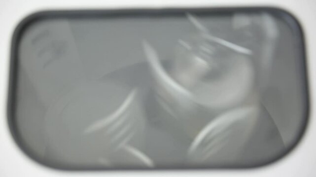 A centrifuge is blurry and spinning vials or tubes filled with liquid in a lab. The centrifuge machine is used for separating liquids in scientific processes.