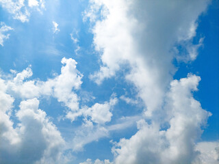 Clear blue sky background with fluffy white clouds on a sunny day. Blue sky with cloud. Soft white clouds floated in the blue sky that looked like soft cotton floating in the air. Beautiful blue sky