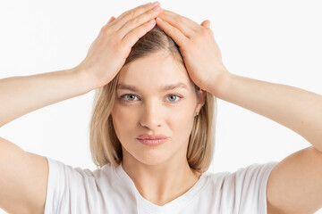 Naklejka premium Beauty, lifestyles, make-up concept. Close-up studio portrait of young and beautiful woman with her hands on head. Model wearing white t-shirt