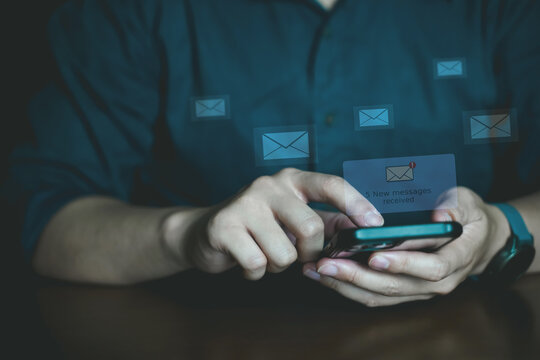Young Professional Using Phone with Email Notification Icons. - Powered by Adobe