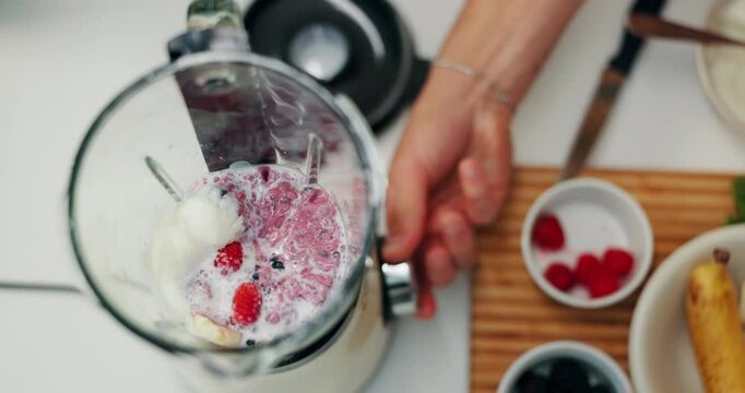 Fruit, blender and hands with milk in kitchen for breakfast with diet, wellness and health in home. Nutrition, top view and person with equipment for smoothie beverage with weightloss in apartment.