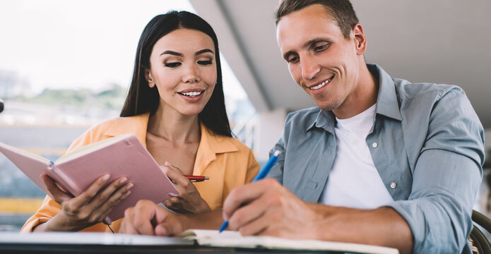 Content students writing in notebooks together - Powered by Adobe