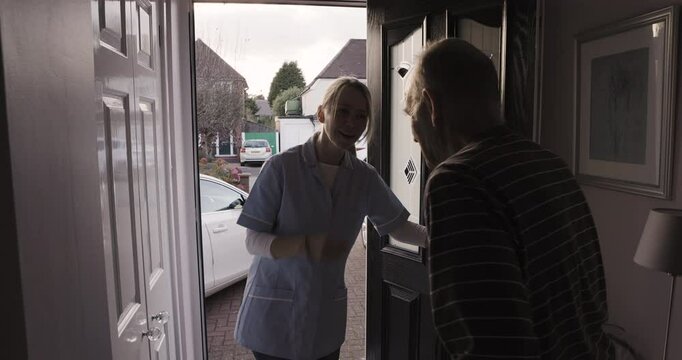 Door, visit and opening of senior man, greeting and welcome nurse to care home. Old guy answering front door of retirement house for doctor woman to say hello