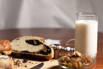 Home-Cooked Poppy Seed Bread with Raisins and Milk on Wooden Surface