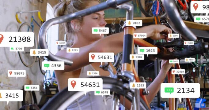 female mechanic adjusting orange bike handlebars in workshop, tech showing floating notifications