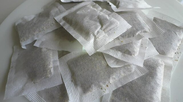 Chamomile tea bags on a turntable. Herbal tea bags. Slow motion