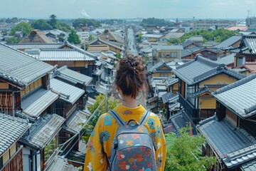 A person in yellow looks at a cityscape from above