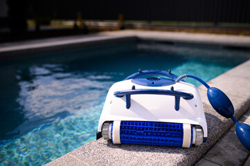 Blue and white robotic vacuum cleaner for cleaning the walls and bottom of the pool and filtering...