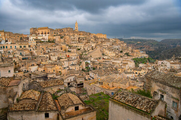 Obraz premium Panoramic view of the ancient town of Matera (Sassi di Matera), Basilicata, Italy. Troglodyte settlement, Cave Houses. UNESCO world heritage site. Travel photography
