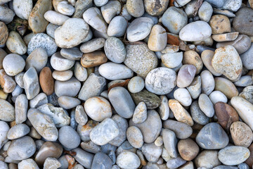 Polished river stones creating a natural textured background