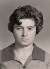 Vintage portrait of attractive young woman dressed in a strict style. Retro photo from 1969.