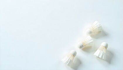 white badminton shuttlecocks scattered on white background